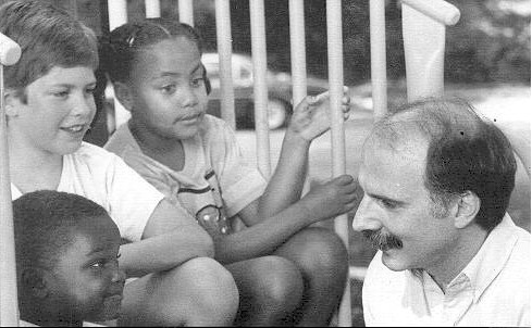 Photo of Mendelson talking with children