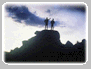 Two men standing on mountain top